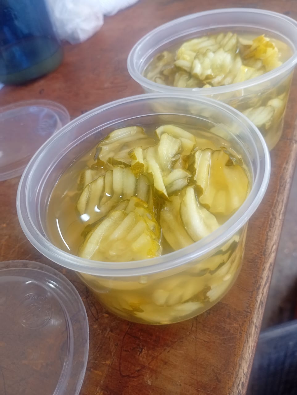 Fresh pickle chips in golden turmeric brine